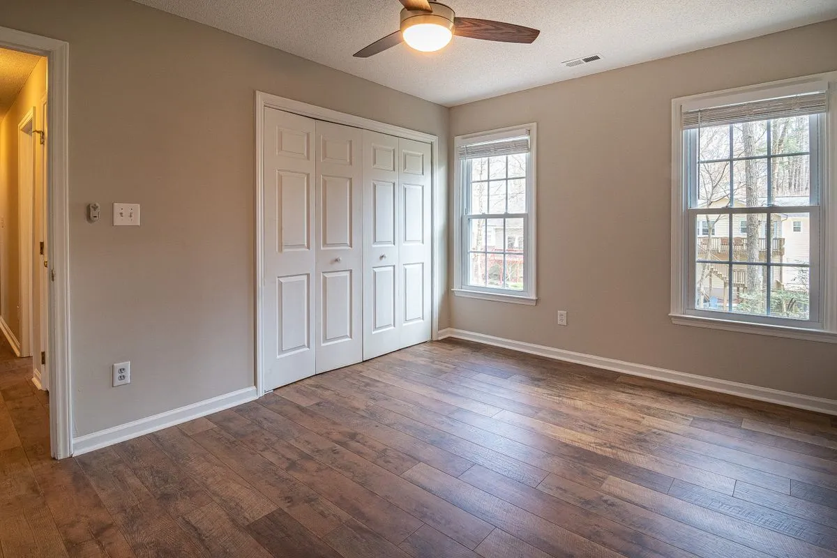 Bedroom with a dark finished timber floor