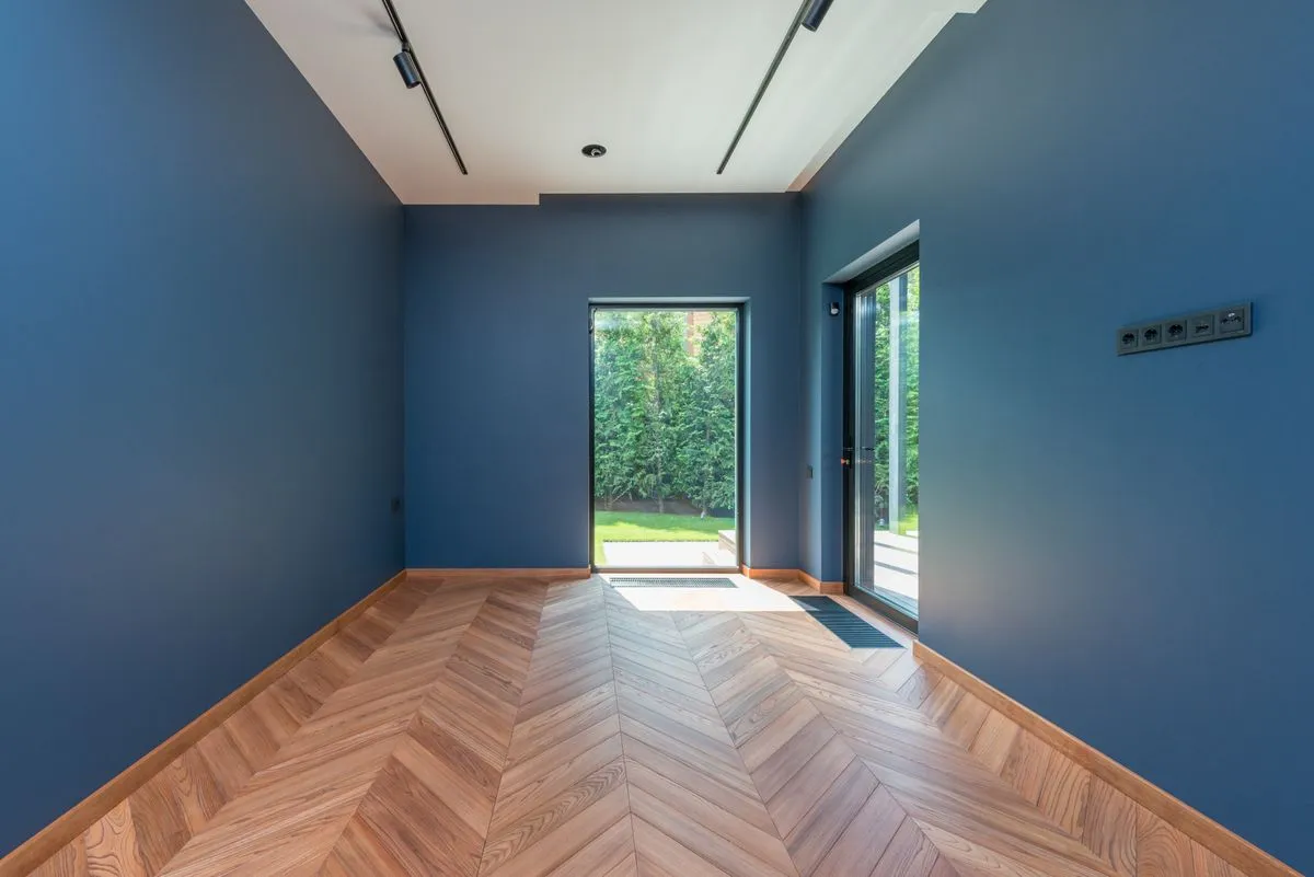 Living room herringbone timber floor with glass garden doors