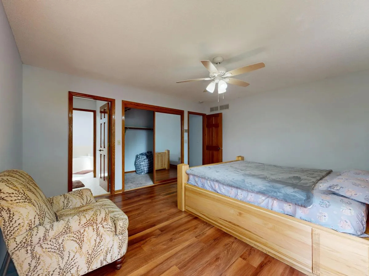 Bedroom finished with warm timber flooring