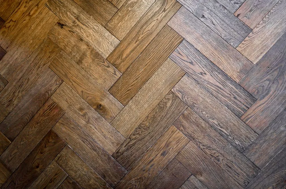 Herringbone timber flooring pattern in warm honey tones