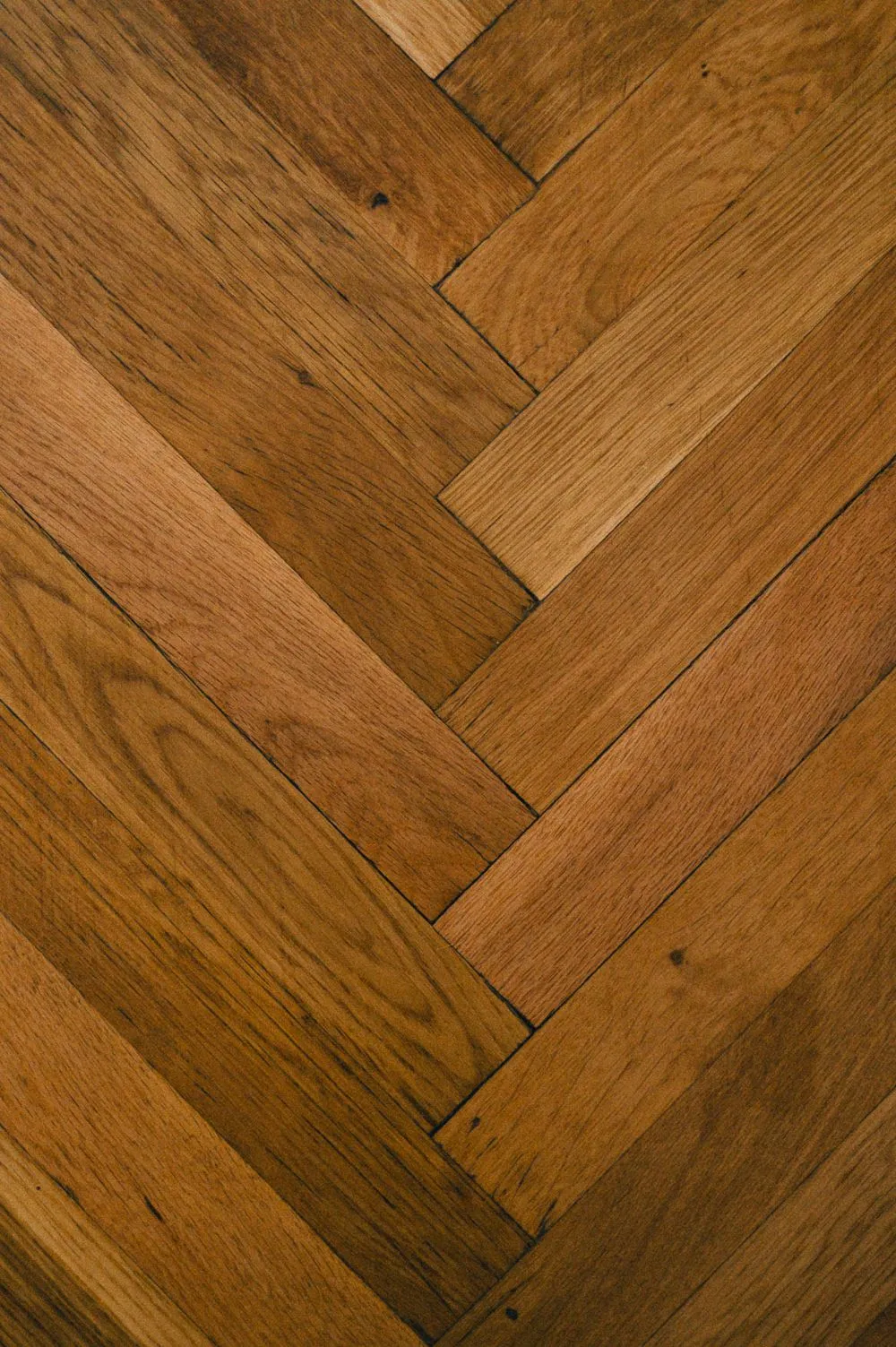 Close-up of a rich brown herringbone parquet floor