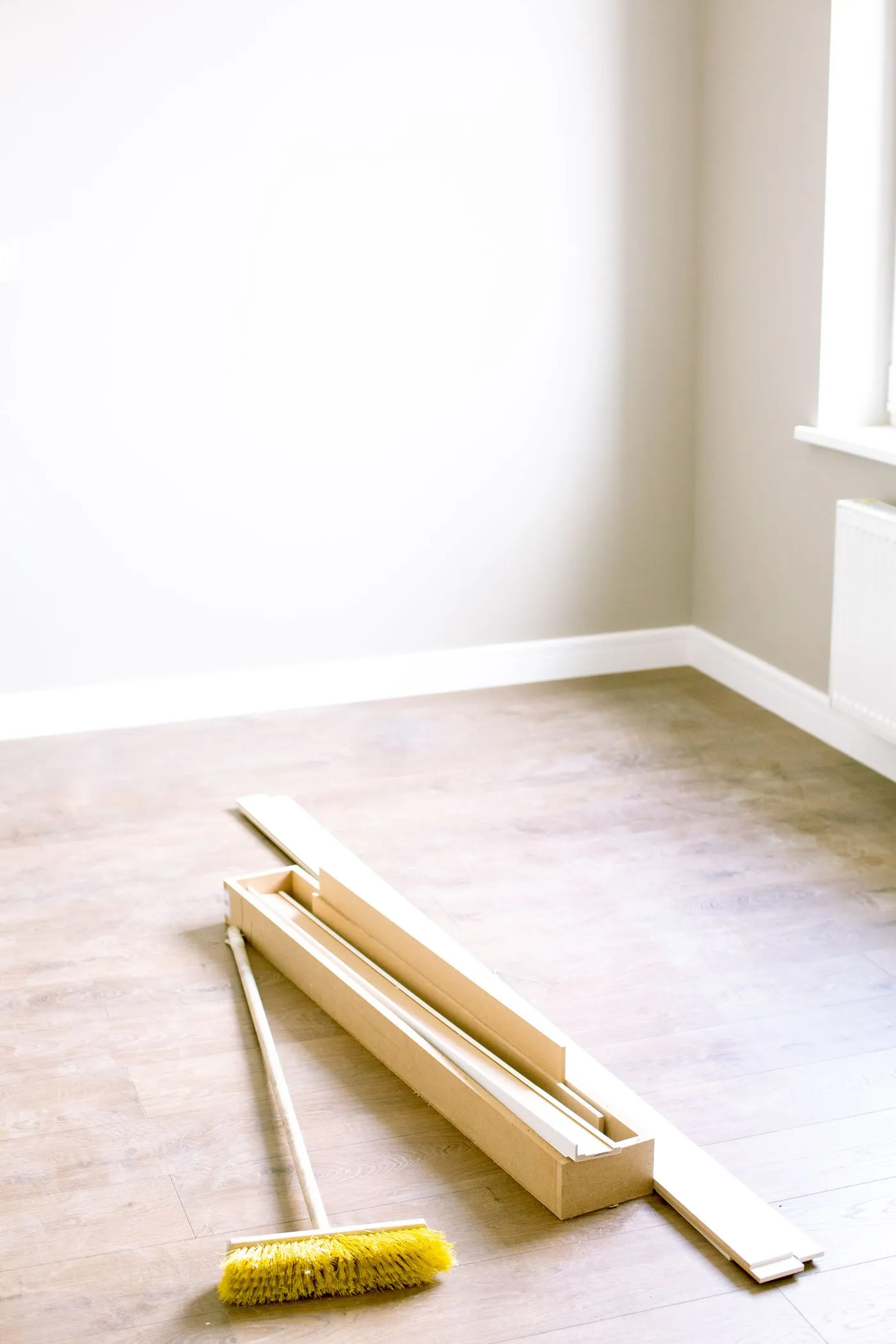 Freshly finished timber flooring in a bright, empty room